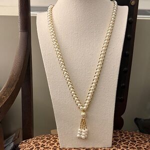 White Faux Pearl Long Tassel Necklace Encased in Gold Tone Chain.